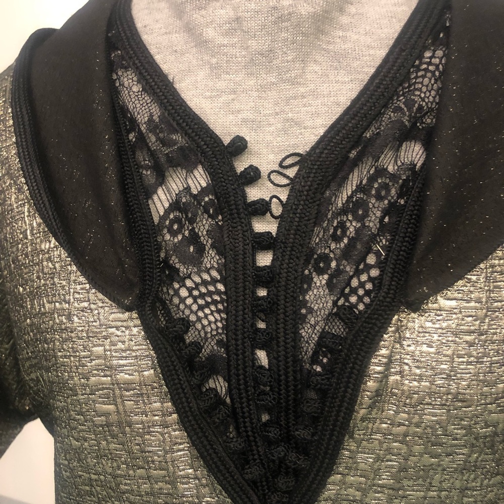 Jalaba with golden fabric, hand made, chest coved with black lace.